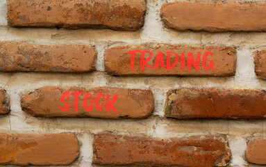 Stock trading symbol. Concept words Stock trading on beautiful brown brick wall. Beautiful brown brick wall background. Business stock trading concept. Copy space.
