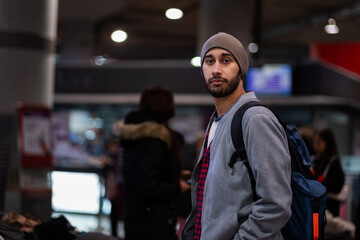 Tourist in train station, urban casual style, half-body portrait, seemingly disoriented.
