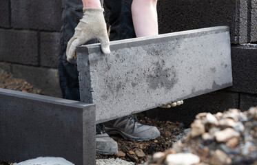 Detail of a man setting a kerbstone outside