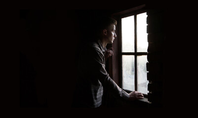 Young guy at the old window