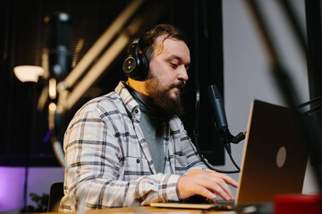 An online blogger speaks into a microphone during a stream. Radio presenter in the studio during...