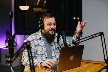 An online blogger speaks into a microphone during a stream. Radio presenter in the studio during...