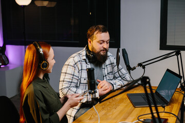Radio presenters communicate during the broadcast of the evening show. Recording a new podcast...