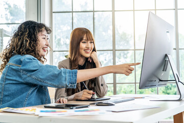 Collaboration of graphic design business people with computer in an office company. Two corporate women in creative marketing team working on project management, Designer teamwork, web design