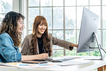 Collaboration of graphic design business people with computer in an office company. Two corporate women in creative marketing team working on project management, Designer teamwork, web design
