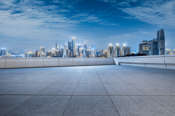 Square floor and city buildings skyline in Chongqing at night