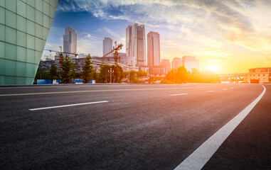 Clean asphalt road and city skyline in Chongqing at sunset