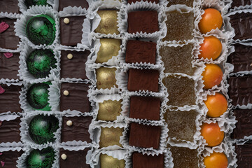 Assorted sweets in a box on a wooden table