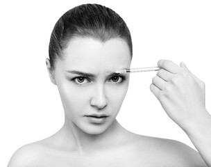 Obraz premium Woman with dissatisfied face makes anti-wrinkles injection.