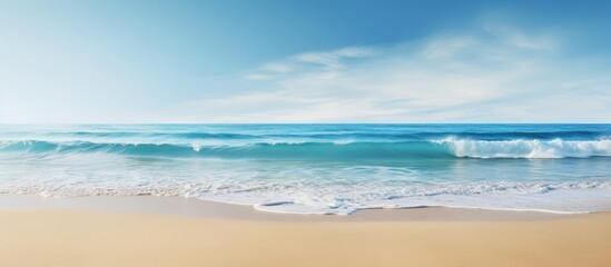 The blue ocean waves crash against the sandy beach creating a stunning landscape with a mesmerizing...