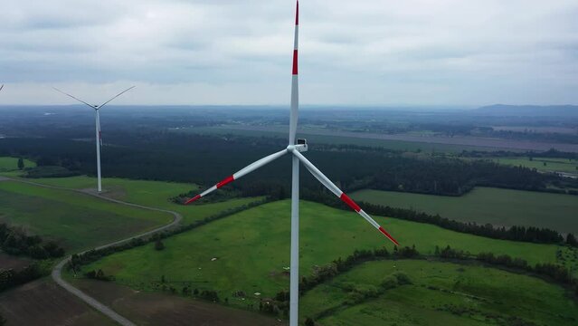 Close up of wind turbine. Aerial voew of wind mills farm park.