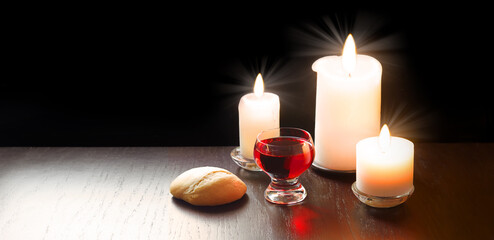 A bowl of wine and bread on the table. Communion symbols