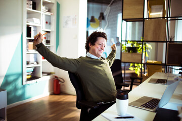 Businessman stretching arms after long day in office