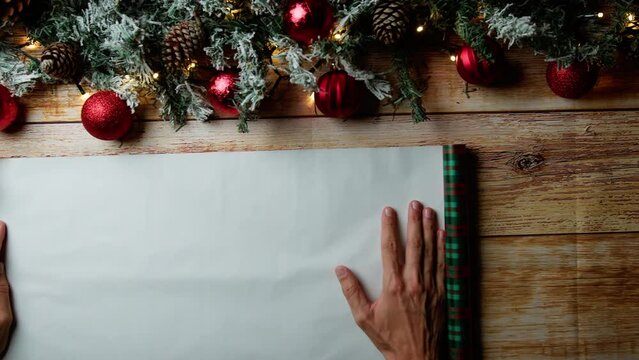 Hand unfolding christmas gift paper 