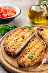 bread and olive oil ready to make toasts with tomatoes, basil, Concept healthy and balanced eating