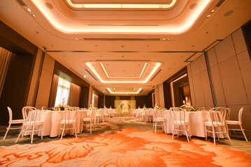Indoor wedding reception ballroom hall with tables