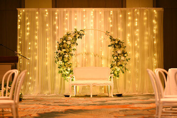 Indoor wedding setty back with lights and flowers