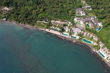 Aerial view of luxury seaside villas on sunny day. Manggis, Bali, Indonesia.