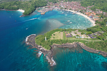 Aerial view of Padangbai bay and Pura Luhur Silayukti hindu temple on sunny day. Manggis, Bali, Indonesia.