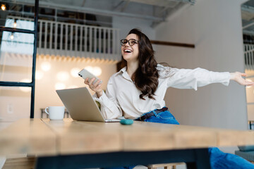 Optimistic female student stretching out arm