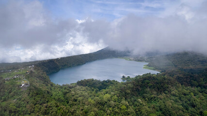 Drone view of Buyan Lake covered with clouds. Bali, Indonesia.
