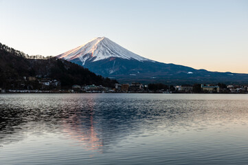 Mount Fuji on a bright winter morning, as seen from across lake Kawaguchi, and the nearby town of Kawaguchiko.