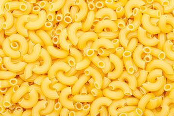 Uncooked macaroni elbow shape pasta texture background