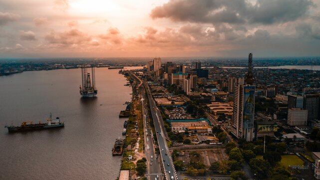 Aerial view of Lagos waterside buildings and roads at sunset