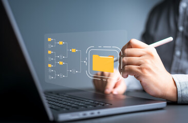 Businessman drag folder icon on virtual screen. Document Management System, Enterprise asset or content management. Document sharing and backup online document files and data for efficient archiving.