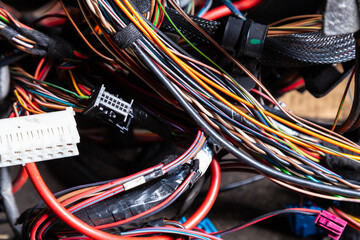 A cable of matted wires of different colors with connectors in the electrical wiring of the car. Internet line in the work of the provider.