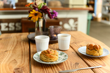 Delicious cardamom buns and coffee on table in cafe-2