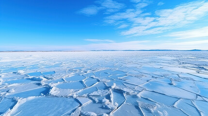 Blue ice and cracks on the surface of the ice. Frozen lake under a blue sky in the winter.