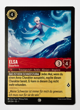 Hamburg, Germany - 10312023: detail macro photo of the German Ravensburger trading card Elsa from the Disney lorcana The first chapter set on white paper background.