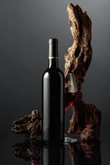 Poster Red wine and old snag on a black background. © Igor Normann