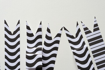 black and white banner or ribbon shapes folded 3d on blank paper