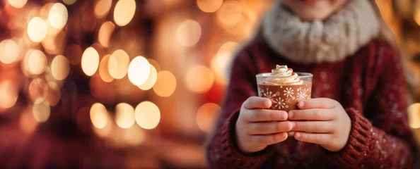 Fotobehang Hands holding a cup of hot chocolate in a fabulous Christmas atmosphere, with decorations and bokeh,. © 18042011