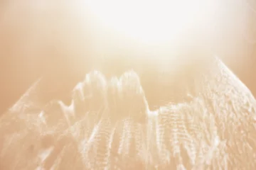 Rolgordijnen White shiny glare from sunlight on beige background, abstract nature photo with sunshine flare, neutral color minimal aesthetic light effect, optical blur glow, defocused natural backdrop © yrabota