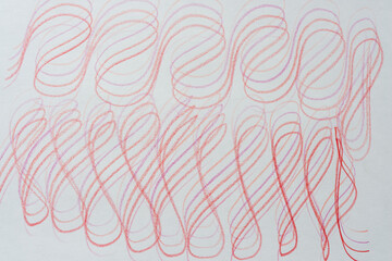 multiple cursive lines mostly in orange or red arranged on blank paper
