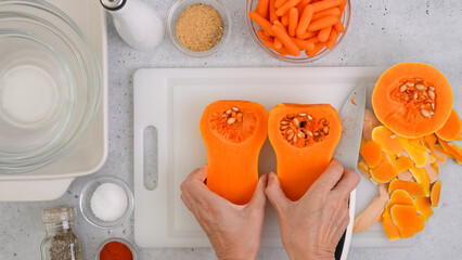 Butternut squash soup recipe, preparation process. Raw vegetables and spices close-up on the...