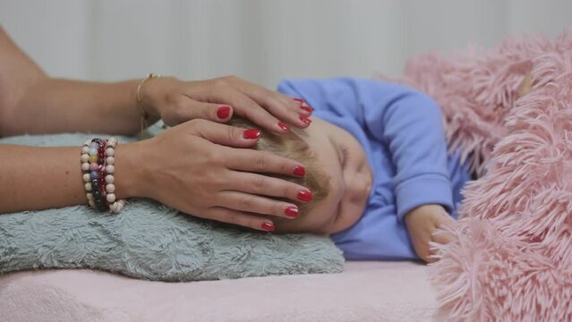 Woman healer performing access or consciousness bars to young boy, a pseudoscientific method of alternative medicine that focuses on massaging various points on the head, alternative medicine concept