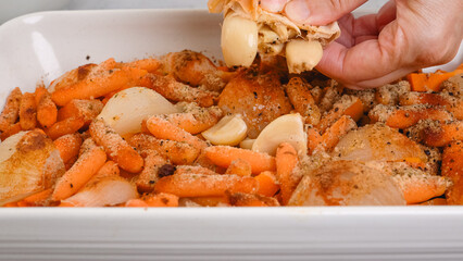 Roasted butternut squash soup recipe, preparation process. Roasted vegetables in a ceramic baking dish, close-up