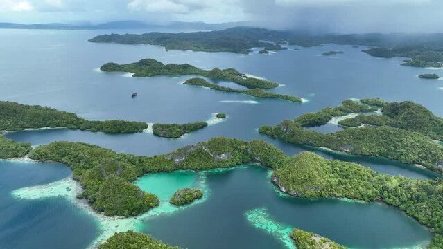 Rain clouds approach the incredible islands of Pef in Raja Ampat, Indonesia. These stunning islands are fringed by mangrove trees and surrounded by beautiful coral reefs.