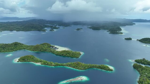 Rain clouds approach the incredible islands of Pef in Raja Ampat, Indonesia. These stunning islands are fringed by mangrove trees and surrounded by beautiful coral reefs.