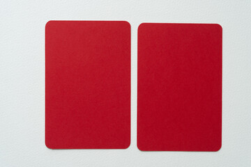 two red cards placed side by side on blank paper