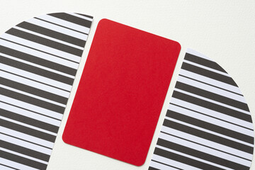 machine-cut paper with stripes and a red card on blank paper