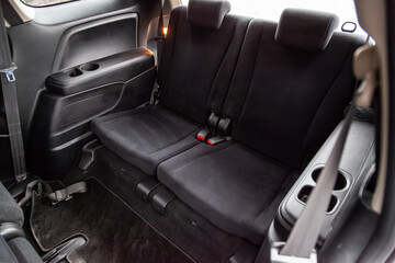 Close-up on rear third row seats with velours fabric upholstery in the interior of an old Korean...
