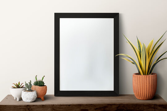 Dark modern blank picture frame on a shelf