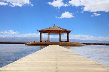 Small wooden gazebo on the pier for meditation