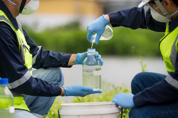 Saving earth. Environmental researchers investigate the condition of canal water for toxic spill, river waste water sampling, Scientist collect water samples for analysis and research on water quality - obrazy, fototapety, plakaty