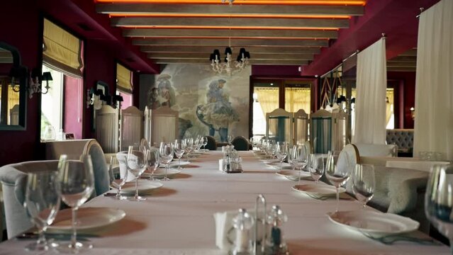 A close-up of a beautifully reserved table at an expensive Italian restaurant being beautifully set up by waiters